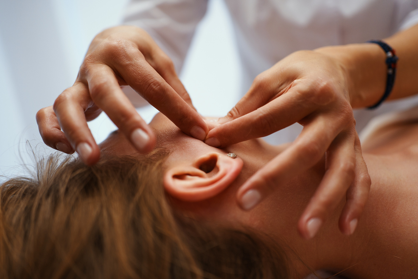 Face massage. Young pretty woman having face massage in the salon