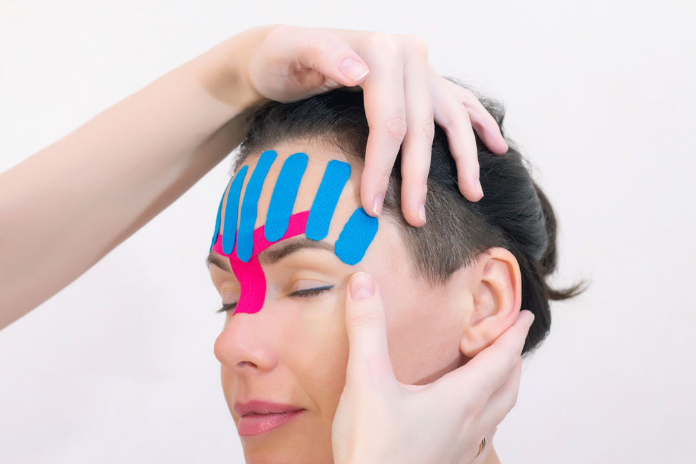 Face taping, close-up of a girls face with cosmetological anti-wrinkle tape. Face aesthetic taping. Non-invasive anti-aging lifting method for reduction of wrinkles