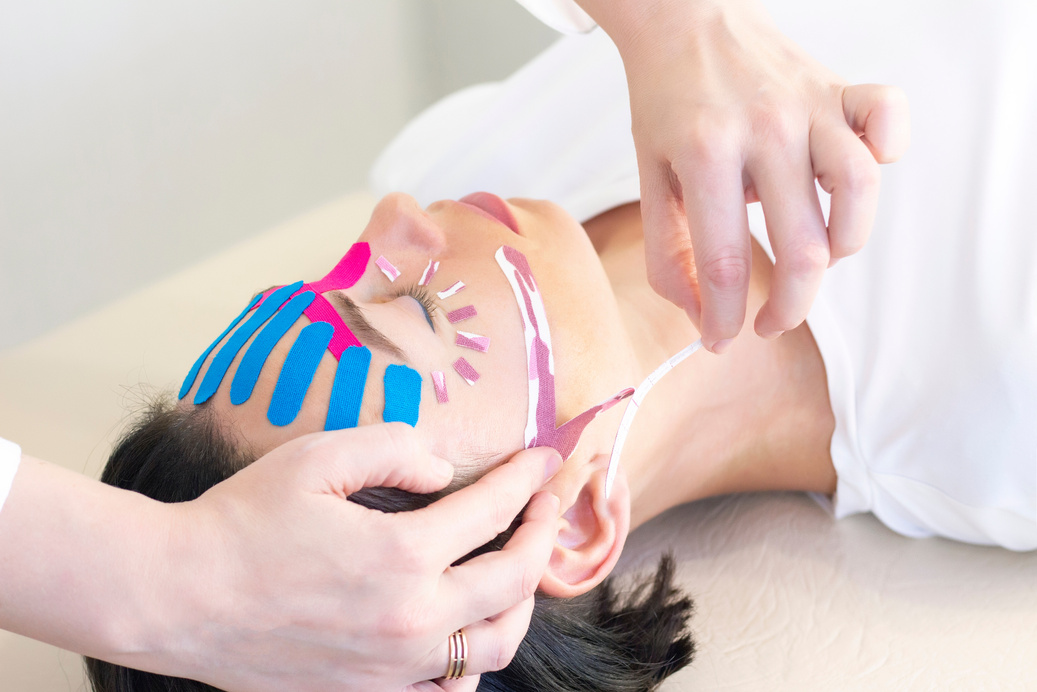 Face taping, close-up of a girls face with cosmetological anti-wrinkle tape. Face aesthetic taping. Non-invasive anti-aging lifting method for reduction of wrinkles